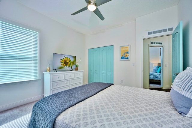 carpeted bedroom featuring ceiling fan and a closet