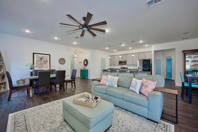 living room featuring dark hardwood / wood-style flooring and ceiling fan