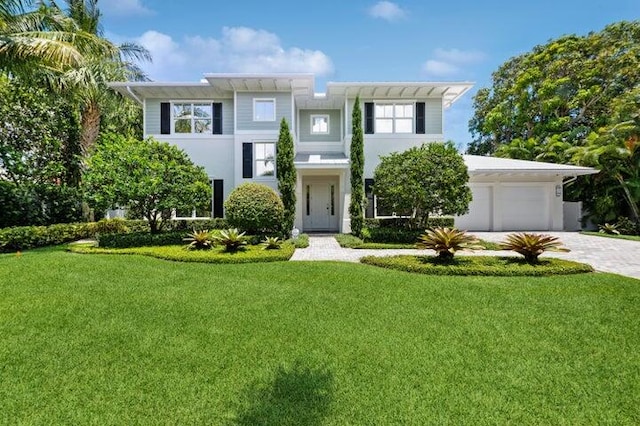 view of front of home featuring a garage and a front lawn