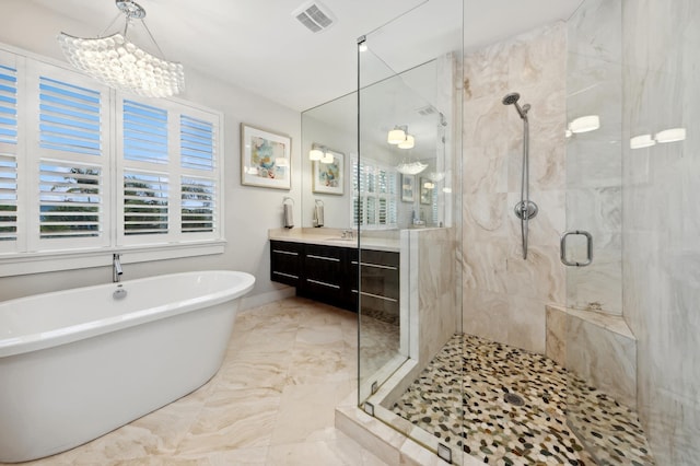 bathroom featuring vanity, plus walk in shower, and a chandelier