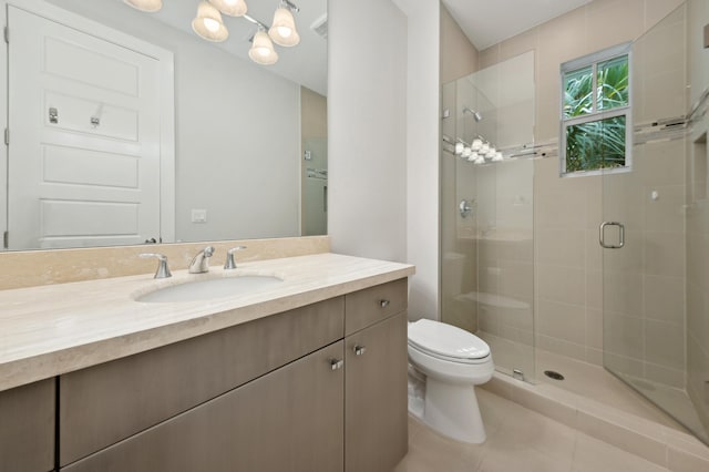 bathroom with tile patterned flooring, vanity, toilet, and a shower with shower door