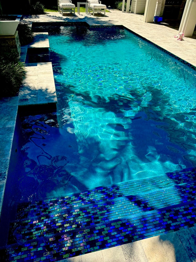 view of swimming pool with a patio