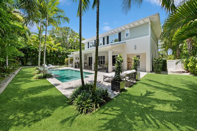 back of property featuring outdoor lounge area, a yard, a patio, and ceiling fan