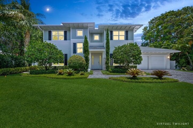 view of front of house with a yard and a garage