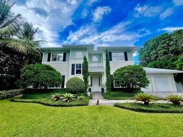 view of front of home featuring a garage and a front lawn