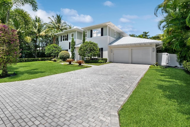 view of front facade featuring a front lawn and a garage