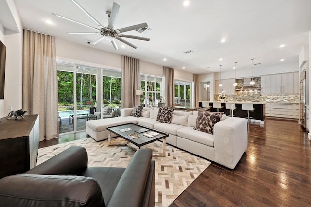 living room featuring ceiling fan and light hardwood / wood-style flooring