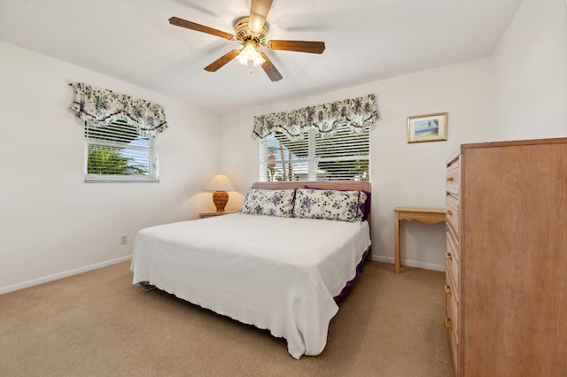 carpeted bedroom with ceiling fan and multiple windows