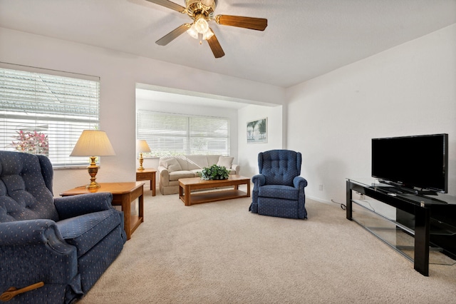 living room with carpet, a wealth of natural light, and ceiling fan