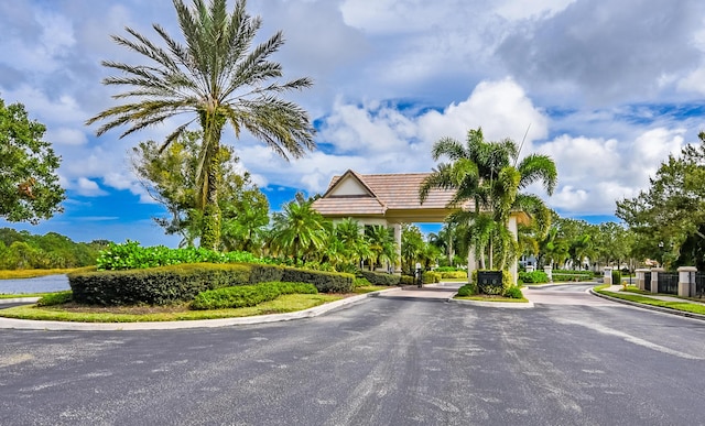 2233 SW Golden Bear Way, Palm City, FL 34990 - view of asphalt street with curbs and a gated entry