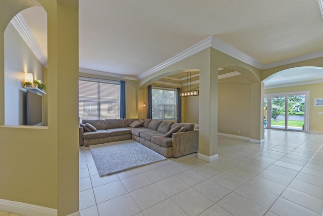 2233 SW Golden Bear Way, Palm City, FL 34990 - living room with crown molding, light tile patterned floors, arched walkways, and baseboards