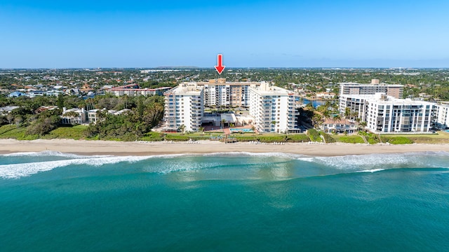 bird's eye view featuring a view of the beach and a water view