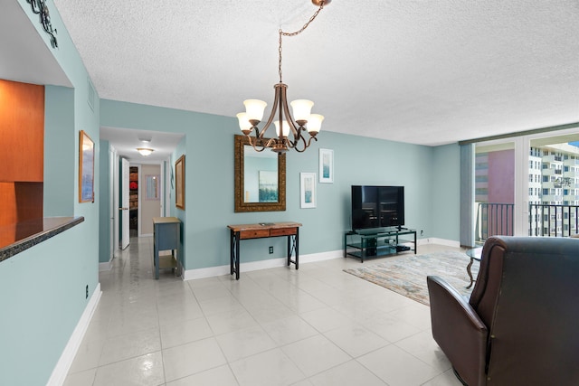 living room with a chandelier, a textured ceiling, and light tile patterned flooring