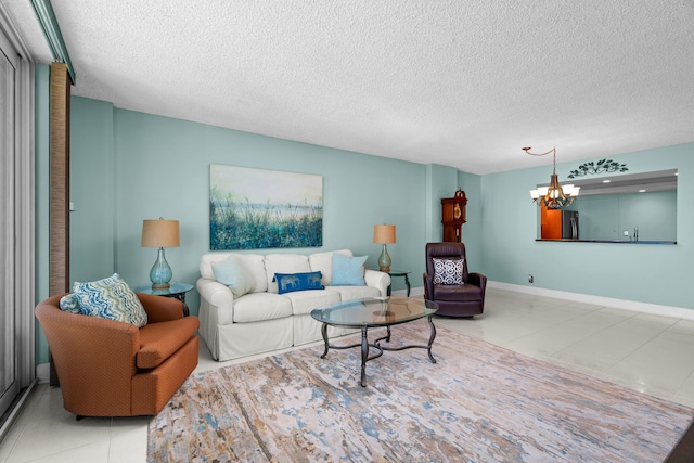 living room with tile patterned flooring, a textured ceiling, and a notable chandelier