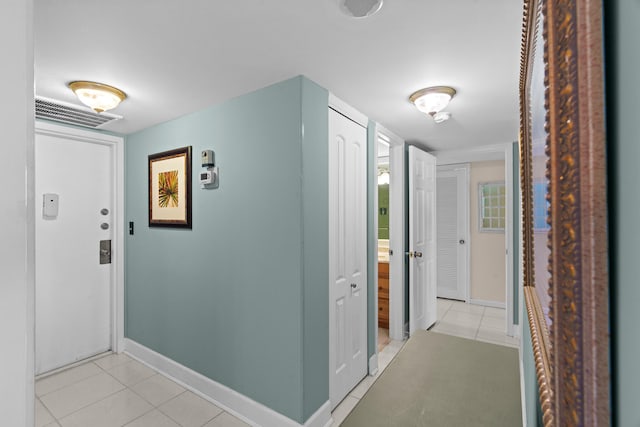 hall featuring light tile patterned flooring