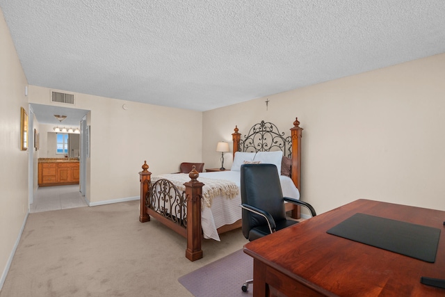 bedroom with light carpet, a textured ceiling, and connected bathroom