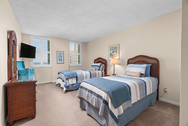 bedroom with carpet and a textured ceiling