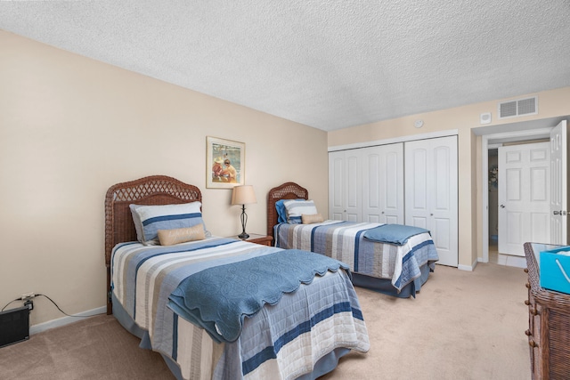 carpeted bedroom featuring a textured ceiling and a closet