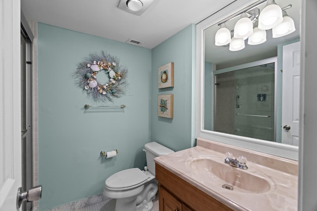 bathroom featuring vanity, an enclosed shower, and toilet