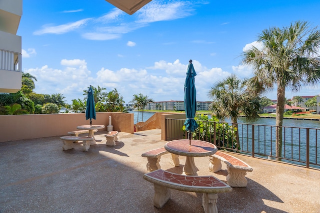 view of patio / terrace featuring a water view and a balcony