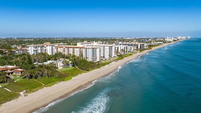 birds eye view of property with a water view and a beach view