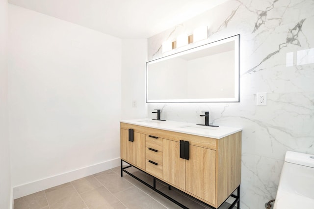 bathroom featuring vanity, tile walls, and toilet