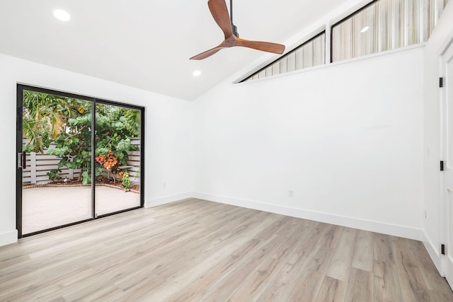 empty room with a high ceiling, light wood-type flooring, and ceiling fan