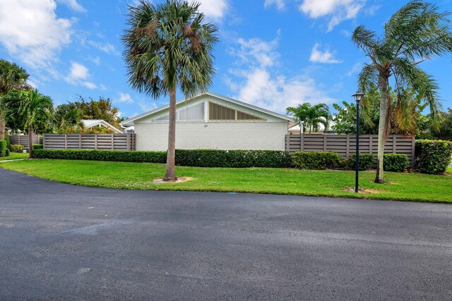 view of side of home with a yard