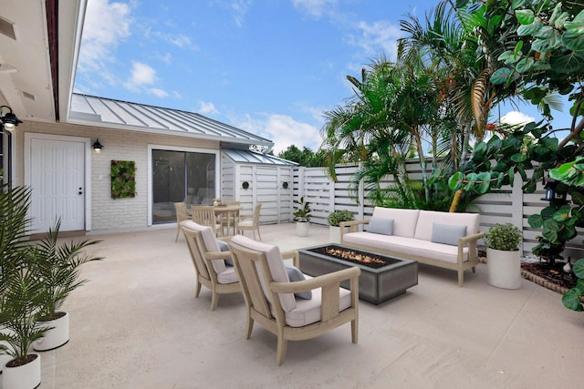 view of patio featuring an outdoor living space with a fire pit