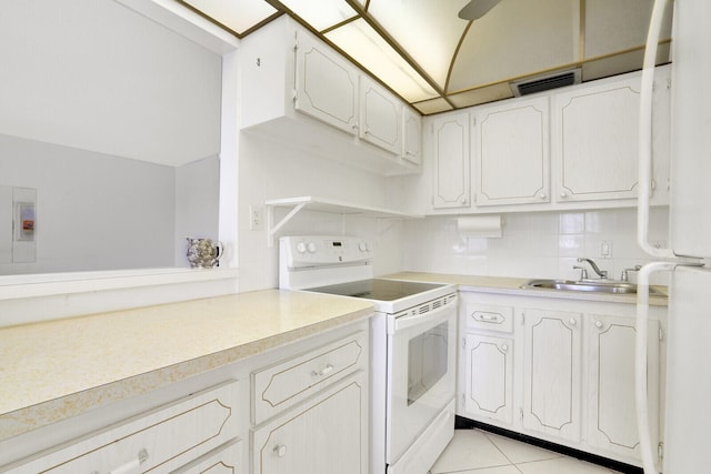 kitchen featuring white cabinetry, electric range, sink, and light tile patterned flooring