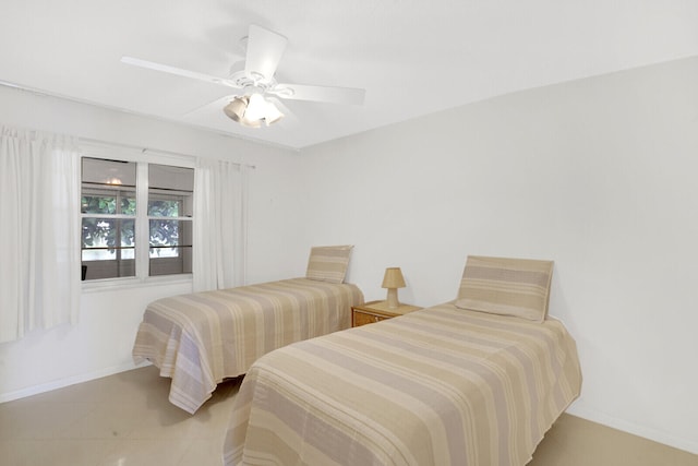 tiled bedroom featuring ceiling fan