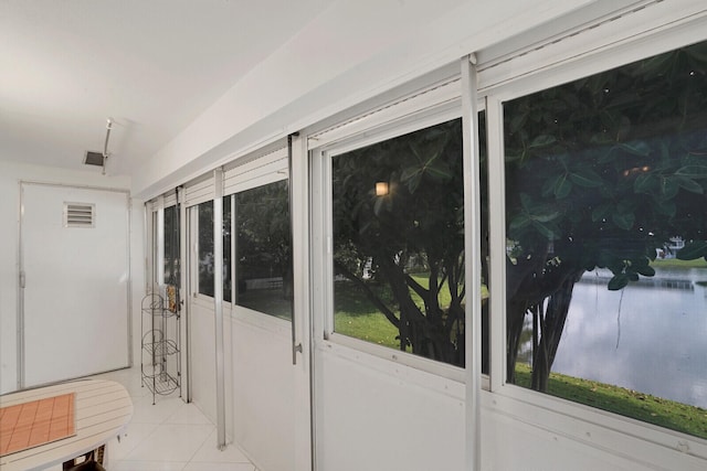 doorway to outside with light tile patterned flooring