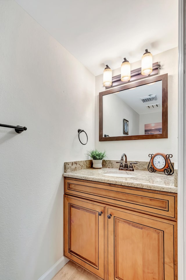 bathroom featuring vanity and hardwood / wood-style flooring