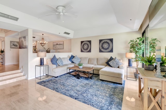 living room with ceiling fan with notable chandelier