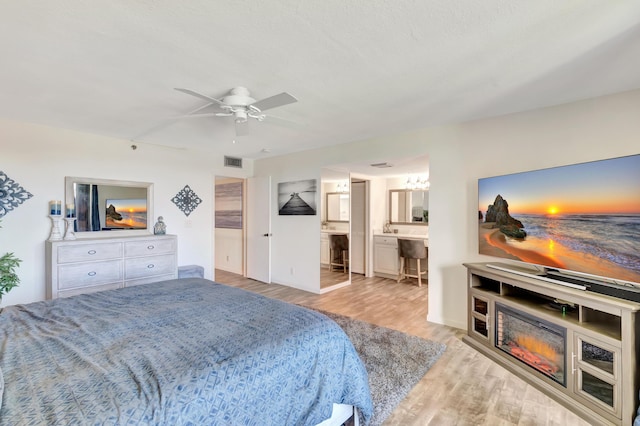 4744 S Ocean Blvd Unit C-112, Highland Beach, FL 33487 - bedroom featuring wood finished floors, ensuite bathroom, ceiling fan, and baseboards