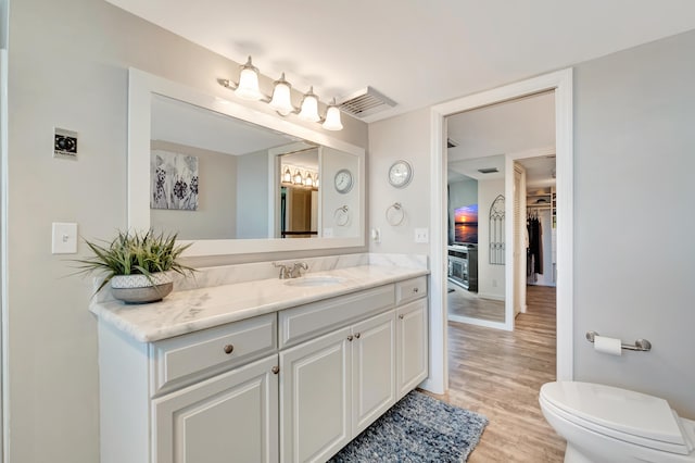 bathroom featuring hardwood / wood-style floors, vanity, and toilet