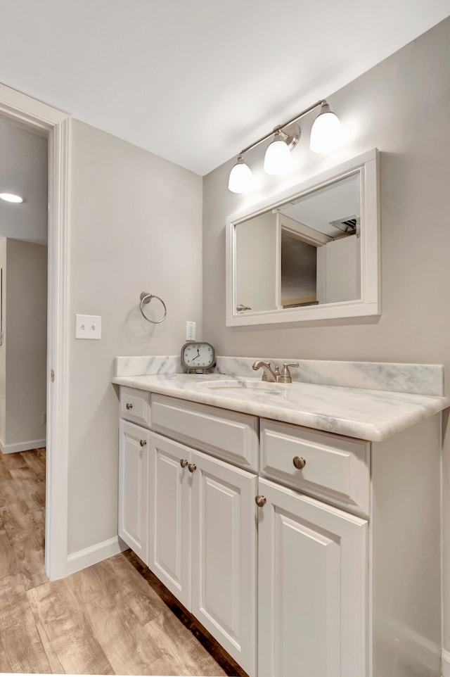 bathroom featuring vanity and hardwood / wood-style flooring