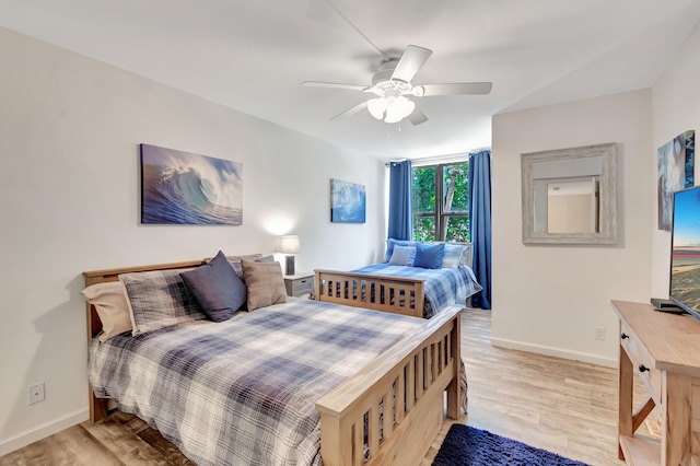 bedroom with light hardwood / wood-style flooring and ceiling fan