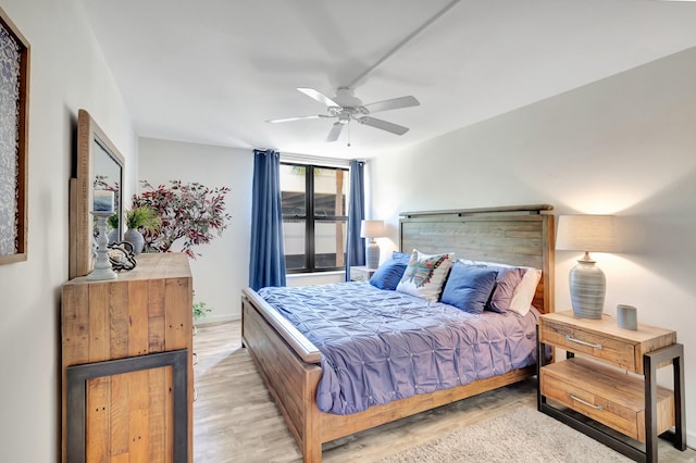 bedroom with ceiling fan and light hardwood / wood-style floors