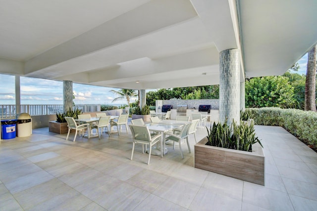 4744 S Ocean Blvd Unit C-112, Highland Beach, FL 33487 - view of patio with outdoor dining space and an outdoor kitchen
