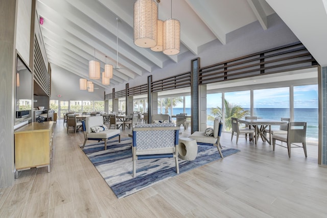 4744 S Ocean Blvd Unit C-112, Highland Beach, FL 33487 - living room with high vaulted ceiling, beamed ceiling, plenty of natural light, a water view, and light wood finished floors