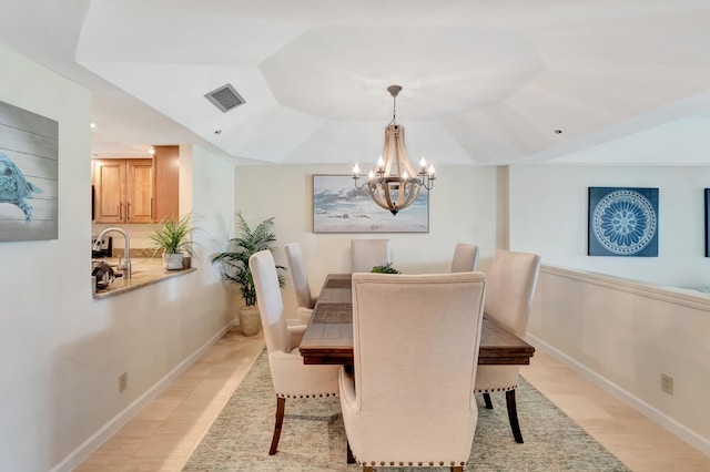 dining space featuring a notable chandelier and sink