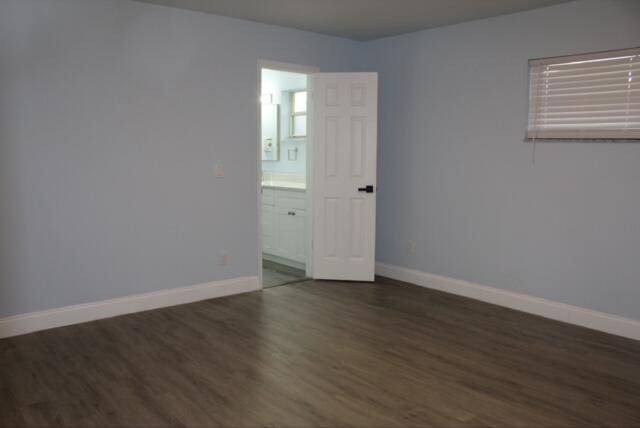 unfurnished room with dark hardwood / wood-style floors