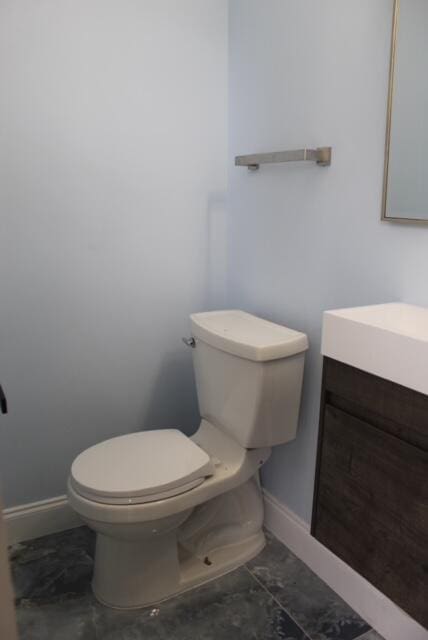 bathroom featuring tile patterned floors, vanity, and toilet