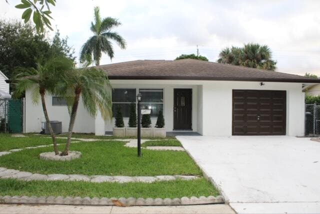 view of front of home with a garage, covered porch, and a front lawn