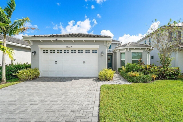 view of front facade featuring a garage and a front lawn