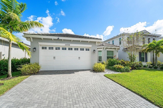 view of front of house with a front yard and a garage