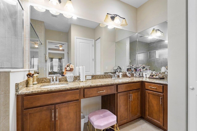 bathroom featuring vanity, ceiling fan, and a shower