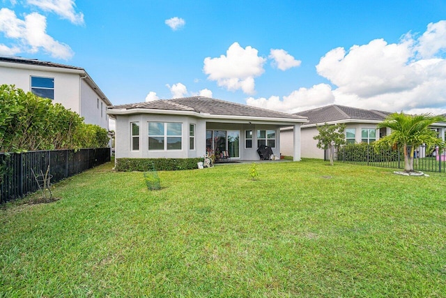 rear view of property with a lawn