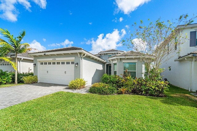 view of front of property with a front lawn and a garage